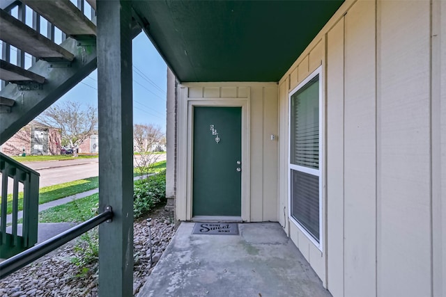 property entrance featuring board and batten siding