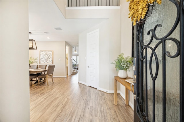 foyer entrance with light hardwood / wood-style flooring