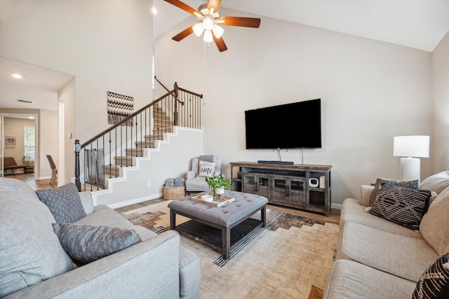 living room featuring hardwood / wood-style flooring, ceiling fan, and high vaulted ceiling