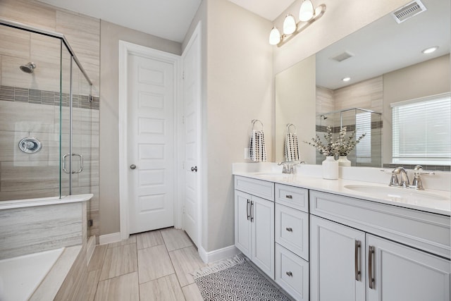 bathroom with vanity and an enclosed shower