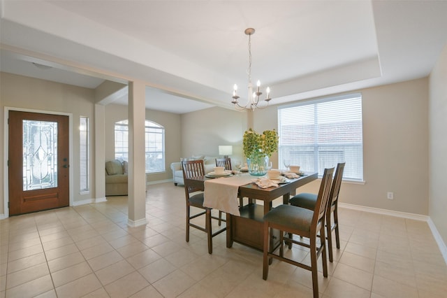 tiled dining area with a chandelier