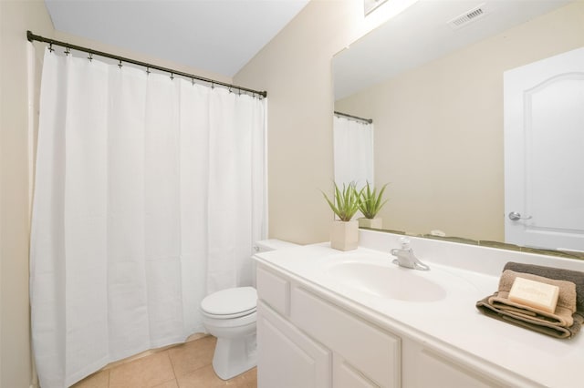 bathroom featuring tile patterned floors, vanity, and toilet