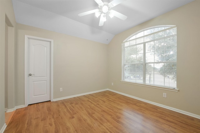 unfurnished room with ceiling fan, light wood-type flooring, and lofted ceiling