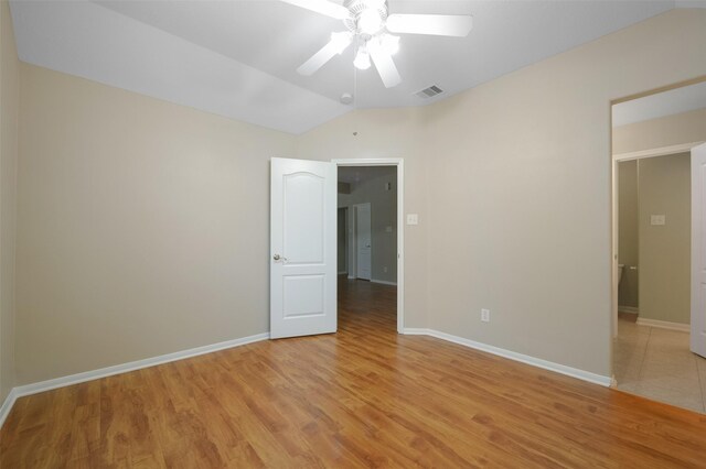 spare room with light hardwood / wood-style flooring, ceiling fan, and lofted ceiling