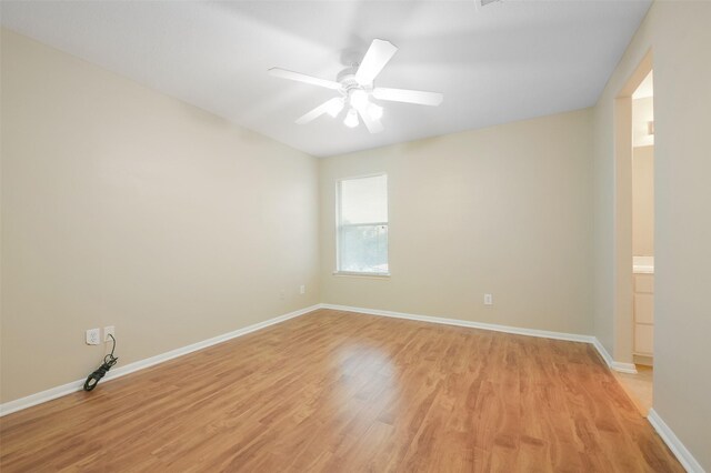 spare room with ceiling fan and light wood-type flooring