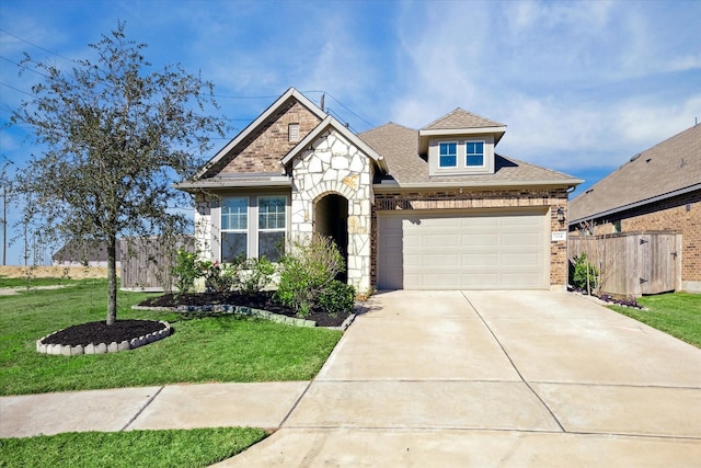 view of front of property featuring a front yard and a garage