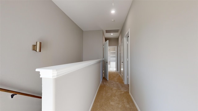 hall with light carpet, baseboards, visible vents, an upstairs landing, and recessed lighting