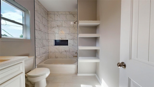 full bathroom featuring built in shelves, vanity, tiled shower / bath combo, and toilet