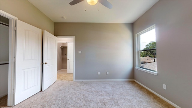 unfurnished bedroom featuring light carpet, ceiling fan, and baseboards