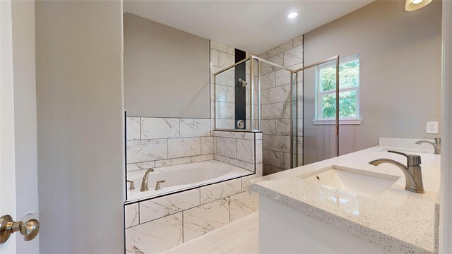 bathroom with vanity and separate shower and tub