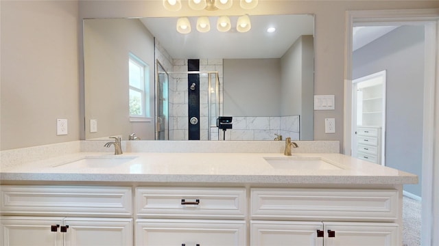 full bath featuring double vanity, a stall shower, and a sink