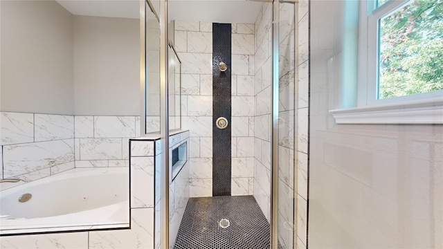 full bath featuring a whirlpool tub and a shower stall