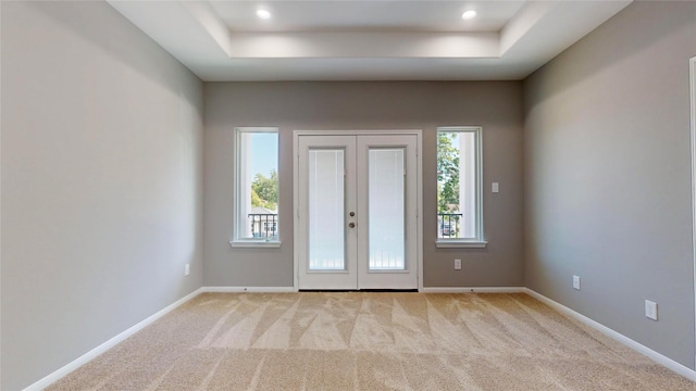 entrance foyer featuring light colored carpet and french doors