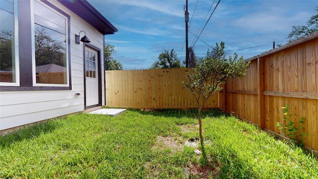 view of yard with a fenced backyard