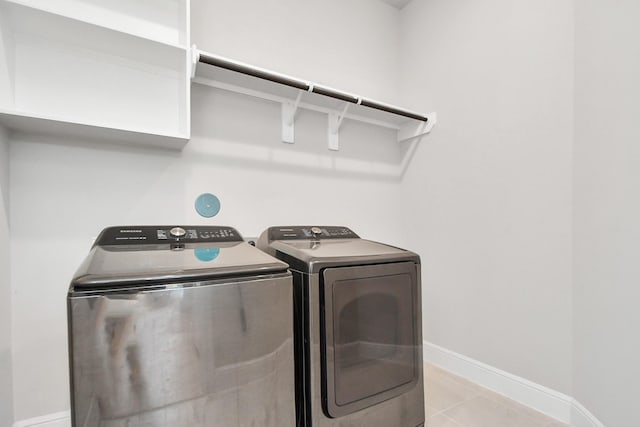 laundry area featuring independent washer and dryer and light tile patterned flooring