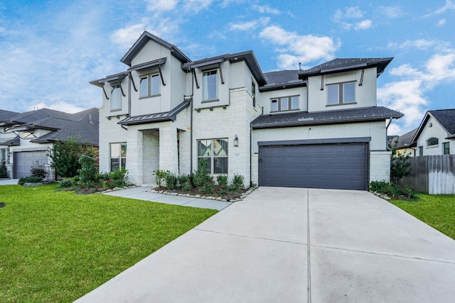 view of front of house featuring a garage and a front lawn