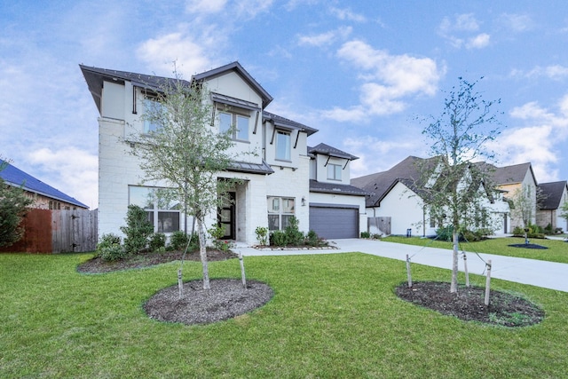 view of front facade with a garage and a front yard