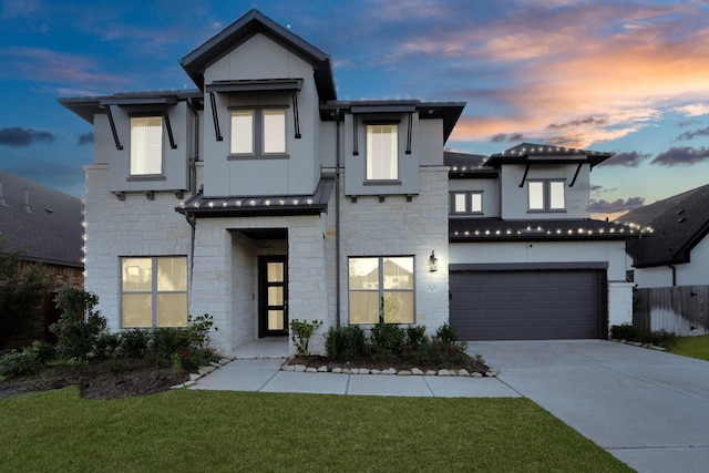 view of front of house with a yard and a garage