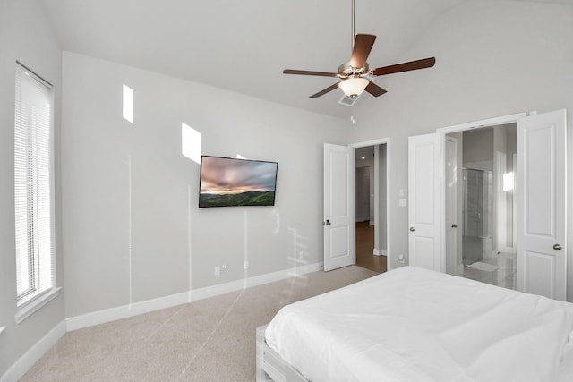 bedroom featuring connected bathroom, ceiling fan, high vaulted ceiling, and light carpet