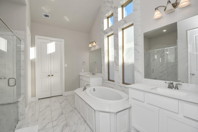 bathroom featuring vanity and independent shower and bath