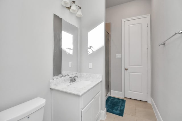 bathroom featuring walk in shower, tile patterned flooring, vanity, and toilet