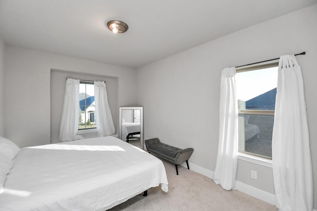 bedroom with light colored carpet