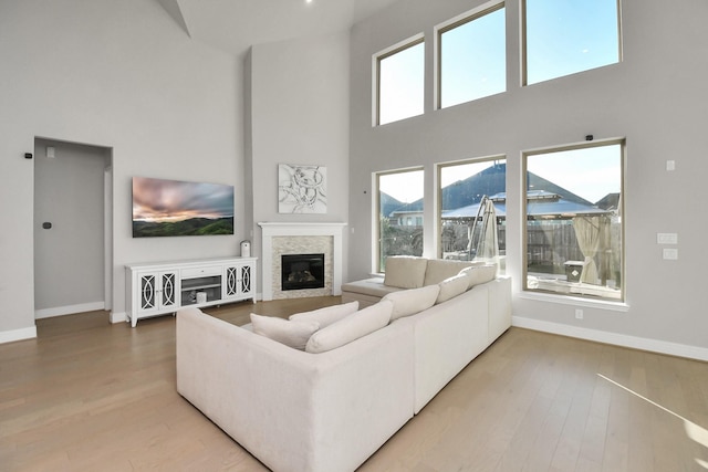 living room featuring a towering ceiling and wood-type flooring