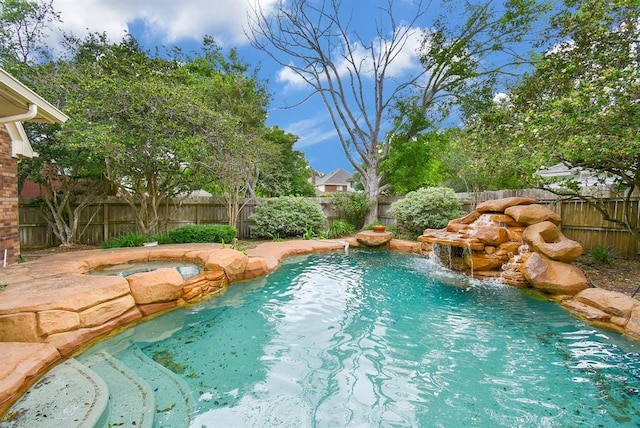 view of pool with pool water feature and an in ground hot tub