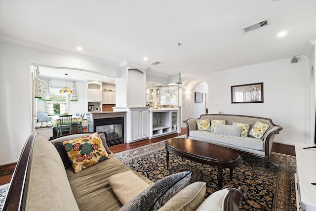 living room featuring dark hardwood / wood-style flooring and ornamental molding