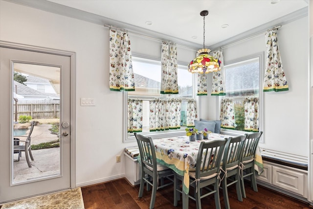 dining space with dark hardwood / wood-style flooring and ornamental molding