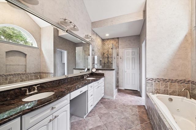 bathroom featuring tile patterned floors, vanity, lofted ceiling, and independent shower and bath