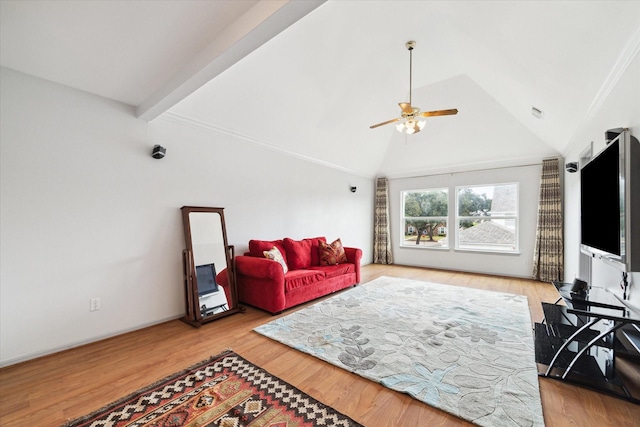 living room with ceiling fan, light hardwood / wood-style flooring, and vaulted ceiling with beams