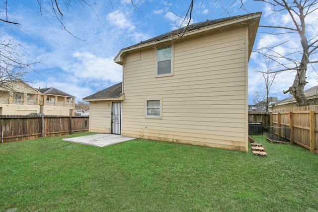 rear view of house featuring a patio area, a yard, and cooling unit