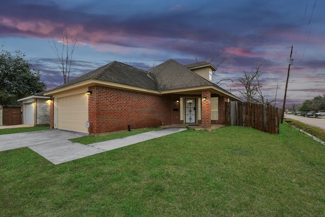 view of front of property with a yard and a garage