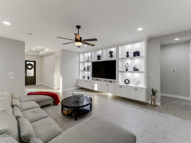 living room featuring ceiling fan, light tile patterned flooring, and built in features