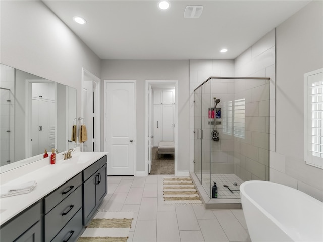 bathroom with tile patterned flooring, vanity, and independent shower and bath