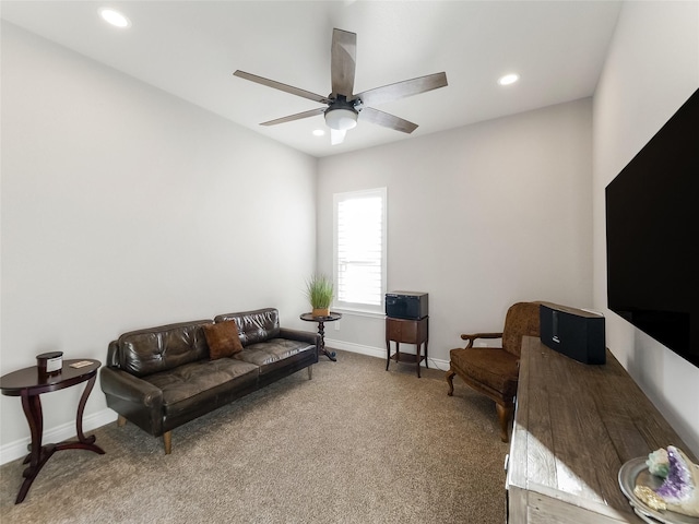 carpeted living room with ceiling fan