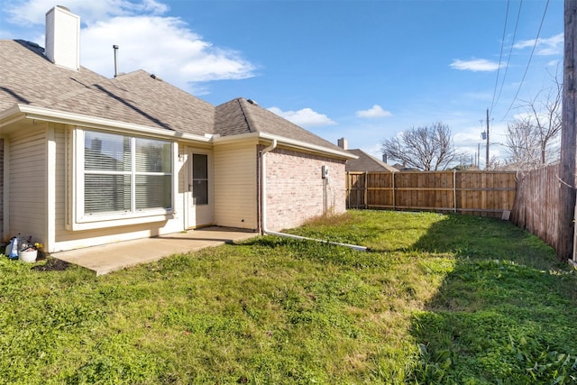 rear view of property with a yard