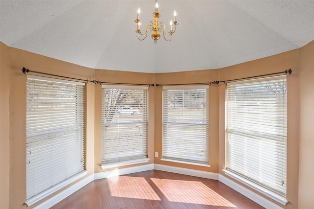 interior space with lofted ceiling and a notable chandelier