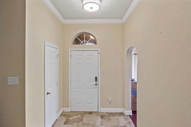 entryway featuring crown molding and a textured ceiling