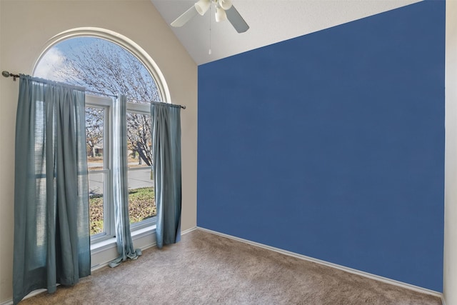 empty room featuring carpet, high vaulted ceiling, and ceiling fan