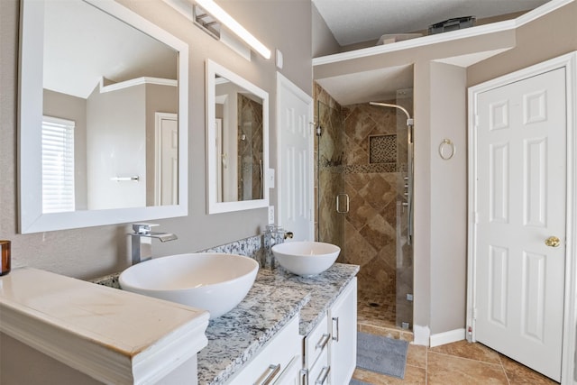 bathroom with tile patterned flooring, vanity, a shower with shower door, and lofted ceiling