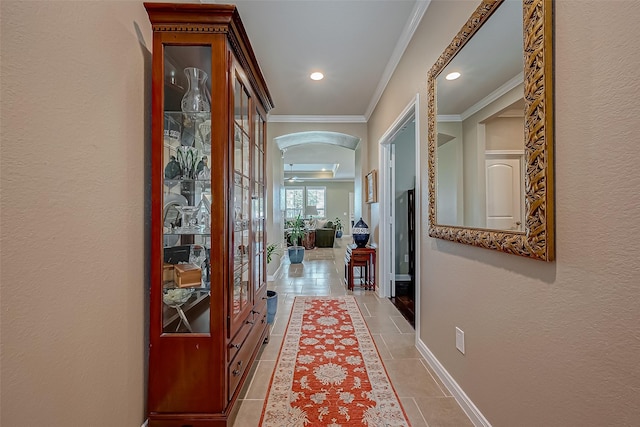 corridor featuring crown molding and light tile patterned floors