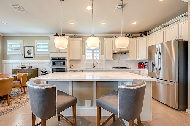 kitchen featuring a center island, sink, hanging light fixtures, and appliances with stainless steel finishes