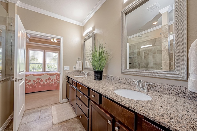 bathroom with tile patterned floors, crown molding, vanity, and walk in shower