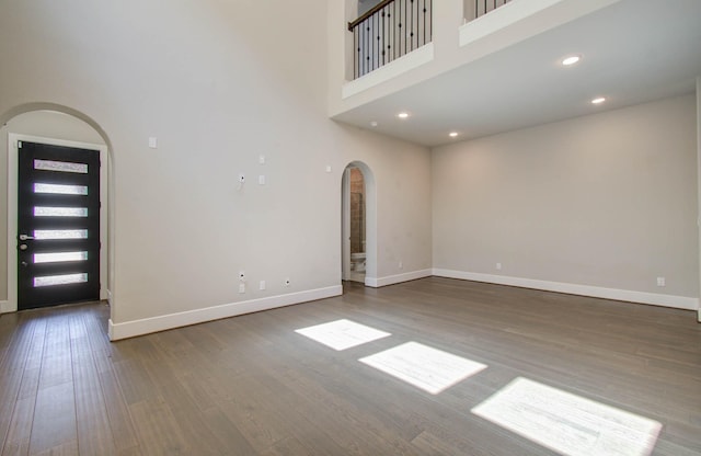 foyer featuring hardwood / wood-style floors and a towering ceiling