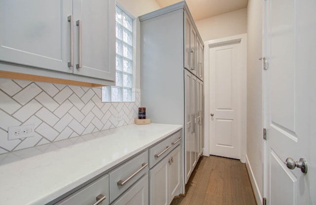 kitchen with decorative backsplash and light hardwood / wood-style flooring