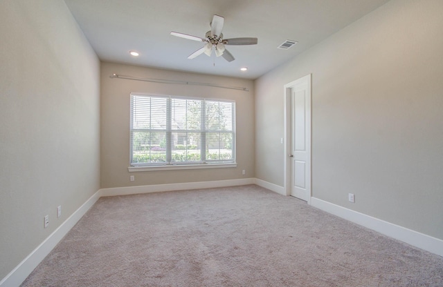 carpeted empty room featuring ceiling fan