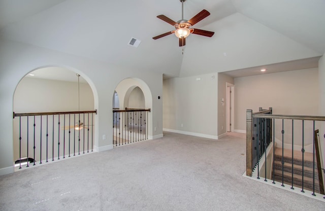 empty room with ceiling fan, lofted ceiling, and light carpet