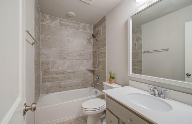 full bathroom with tiled shower / bath, vanity, and toilet